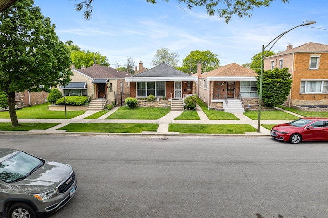 8952 S E End Ave, Chicago, IL 60617 - view of front facade with a front lawn and brick siding
