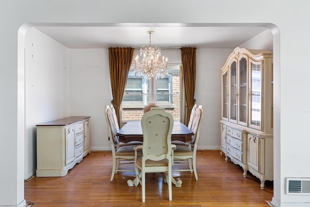 8952 S E End Ave, Chicago, IL 60617 - dining space with a chandelier, wood finished floors, and baseboards