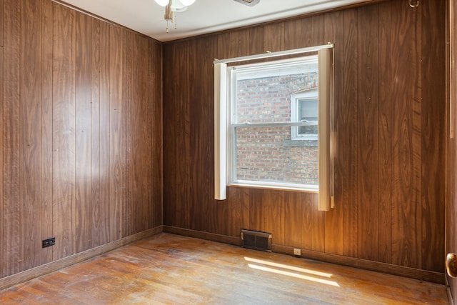 8952 S E End Ave, Chicago, IL 60617 - spare room featuring wood finished floors, a ceiling fan, and wood walls