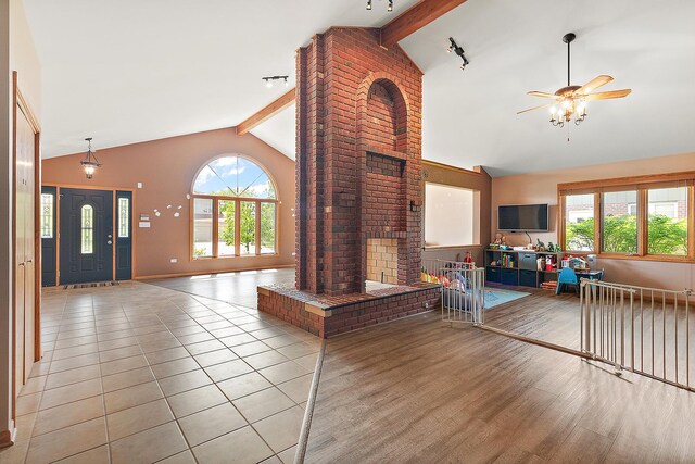 8542 Monaghan Dr, Tinley Park, IL 60487 - living room with healthy amount of natural light, beam ceiling, a ceiling fan, high vaulted ceiling, and light wood-style floors