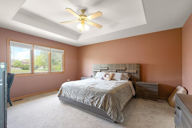 8542 Monaghan Dr, Tinley Park, IL 60487 - bedroom featuring a tray ceiling, light carpet, baseboards, and a ceiling fan