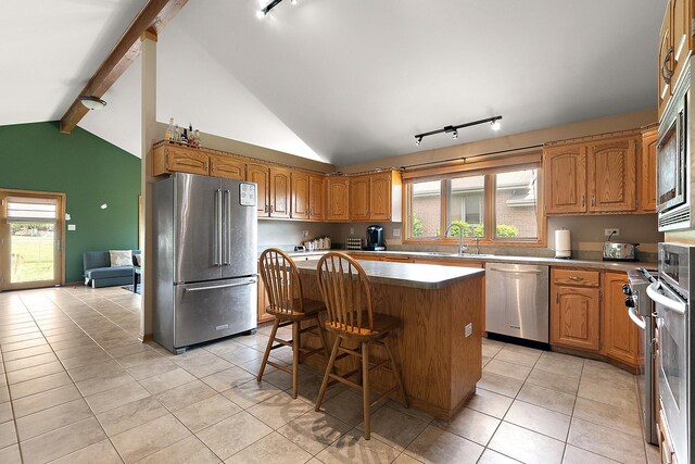 8542 Monaghan Dr, Tinley Park, IL 60487 - kitchen with appliances with stainless steel finishes, track lighting, a center island, light tile patterned floors, and a sink