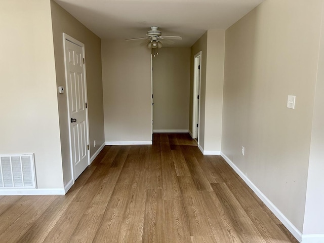 123 N Chicago Ave, Ladd, IL 61329 - unfurnished room with wood finished floors, a ceiling fan, and baseboards