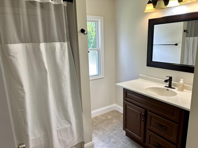 123 N Chicago Ave, Ladd, IL 61329 - bathroom with vanity, tile patterned floors, baseboards, and a shower with curtain