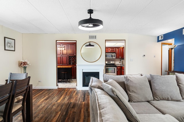 825 Center St Unit 302, Des Plaines, IL 60016 - living area featuring dark wood-style flooring, baseboards, and a glass covered fireplace