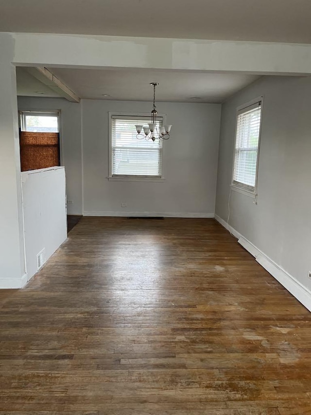 2517 S 4th Ave, North Riverside, IL 60546 - unfurnished dining area with a chandelier, plenty of natural light, wood finished floors, baseboards, and beamed ceiling