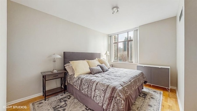 630 N State St Unit 2403, Chicago, IL 60654 - bedroom with baseboards and light wood finished floors