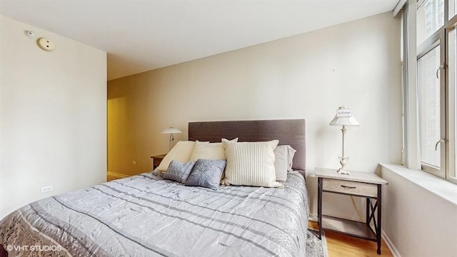 630 N State St Unit 2403, Chicago, IL 60654 - bedroom featuring multiple windows and wood finished floors
