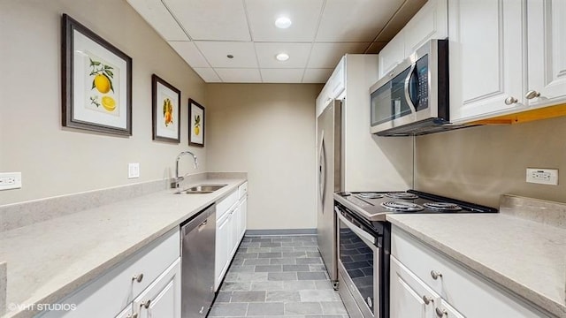 630 N State St Unit 2403, Chicago, IL 60654 - kitchen featuring a sink, stainless steel appliances, recessed lighting, a paneled ceiling, and white cabinetry