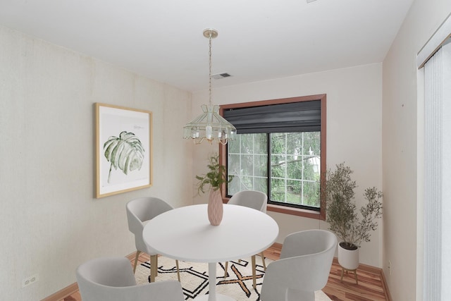 1611 W Partridge Ct Unit 8, Arlington Heights, IL 60004 - dining space featuring wood finished floors, a chandelier, and baseboards