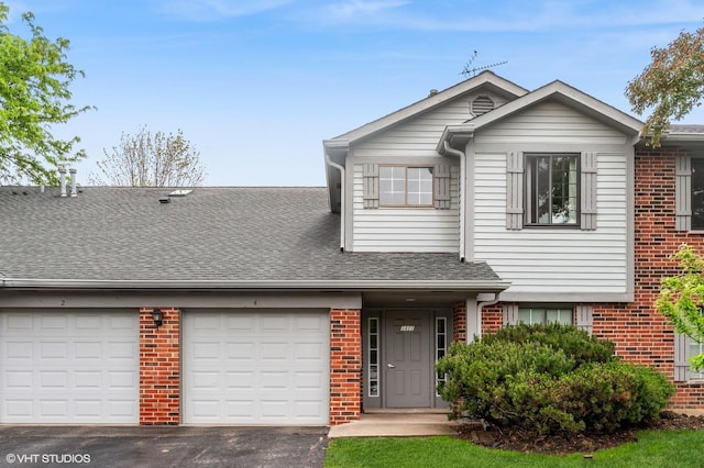 1411 W Partridge Ln Unit 4, Arlington Heights, IL 60004 - view of front of property featuring driveway, brick siding, an attached garage, and a shingled roof