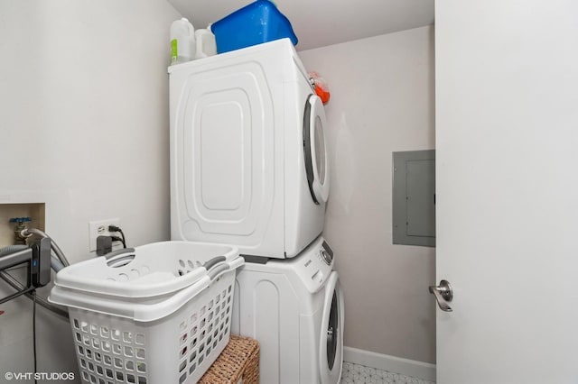 1411 W Partridge Ln Unit 4, Arlington Heights, IL 60004 - laundry room with stacked washer and clothes dryer, electric panel, and baseboards