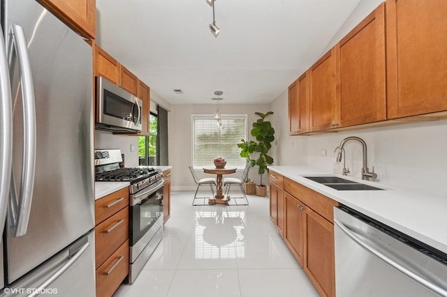 1411 W Partridge Ln Unit 4, Arlington Heights, IL 60004 - kitchen with stainless steel appliances, a sink, light countertops, brown cabinetry, and hanging light fixtures