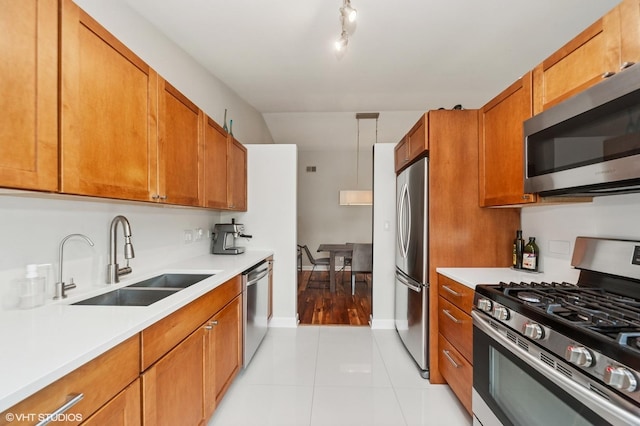 1411 W Partridge Ln Unit 4, Arlington Heights, IL 60004 - kitchen with appliances with stainless steel finishes, a sink, brown cabinetry, light countertops, and light tile patterned floors