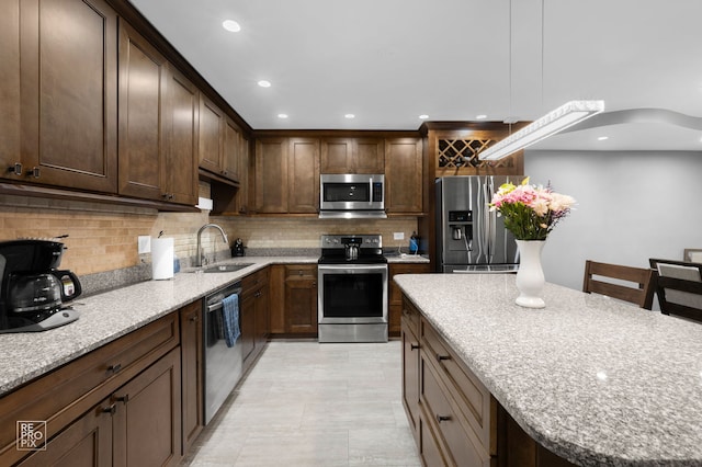 7525 Nantucket Dr Unit 109, Darien, IL 60561 - kitchen featuring appliances with stainless steel finishes, a sink, tasteful backsplash, hanging light fixtures, and recessed lighting