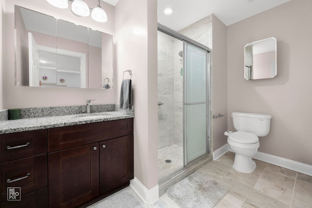 7525 Nantucket Dr Unit 109, Darien, IL 60561 - bathroom featuring baseboards, toilet, a stall shower, and vanity