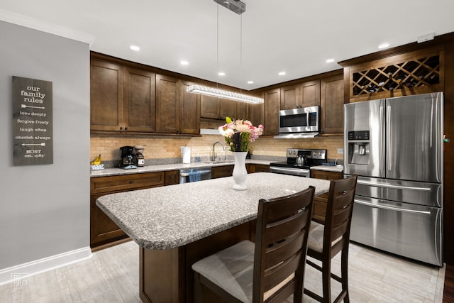 7525 Nantucket Dr Unit 109, Darien, IL 60561 - kitchen with appliances with stainless steel finishes, tasteful backsplash, dark brown cabinetry, pendant lighting, and recessed lighting