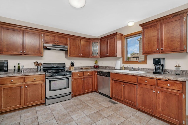 601 High Grove Dr, Minooka, IL 60447 - kitchen with stainless steel appliances, under cabinet range hood, a sink, brown cabinets, and light countertops