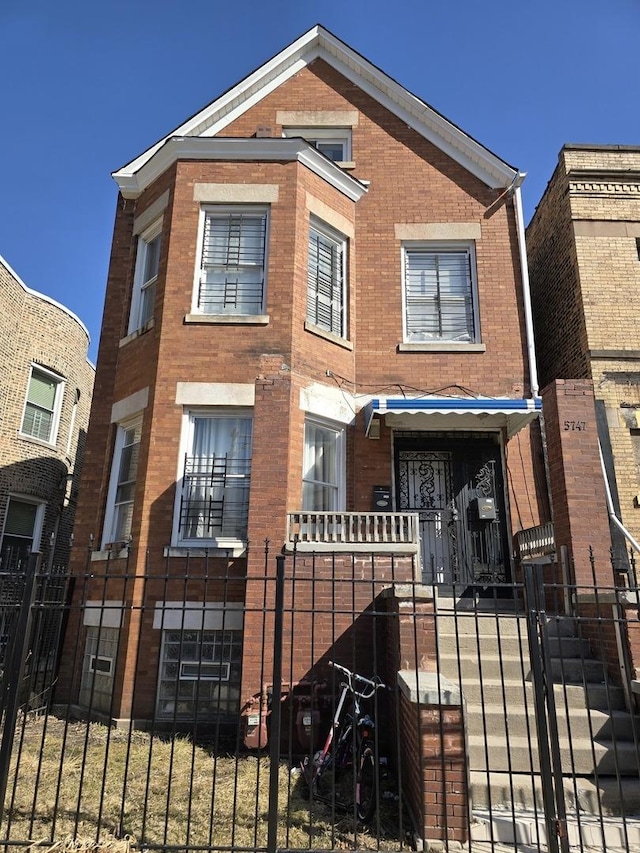 5747 S Laflin St, Chicago, IL 60636 - view of front of house featuring a fenced front yard, brick siding, and a gate