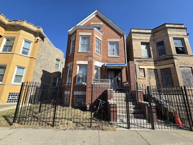 5747 S Laflin St, Chicago, IL 60636 - townhome / multi-family property featuring a fenced front yard and brick siding