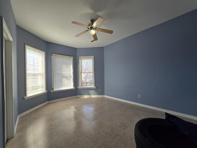 5747 S Laflin St, Chicago, IL 60636 - empty room with healthy amount of natural light, a ceiling fan, and baseboards