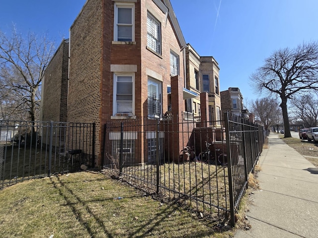 5747 S Laflin St, Chicago, IL 60636 - view of side of property featuring a fenced front yard and brick siding