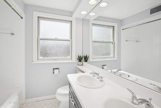 1161 Vernon Dr, Glenview, IL 60025 - full bathroom with healthy amount of natural light, double vanity, tile patterned flooring, recessed lighting, and toilet