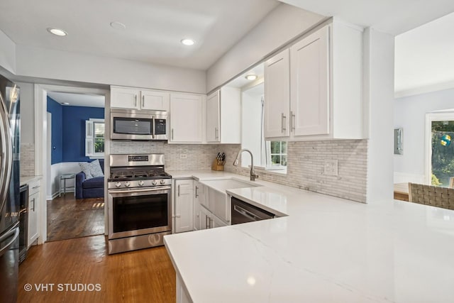 1161 Vernon Dr, Glenview, IL 60025 - kitchen featuring stainless steel appliances, white cabinets, healthy amount of natural light, backsplash, and recessed lighting