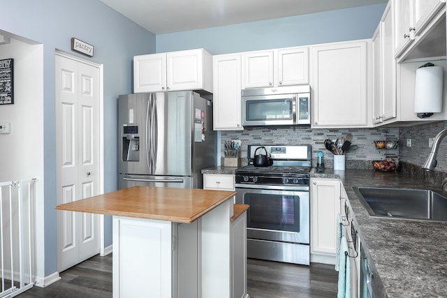 3601 Daisy Ln, Elgin, IL 60124 - kitchen featuring appliances with stainless steel finishes, dark wood-type flooring, a sink, tasteful backsplash, and white cabinets