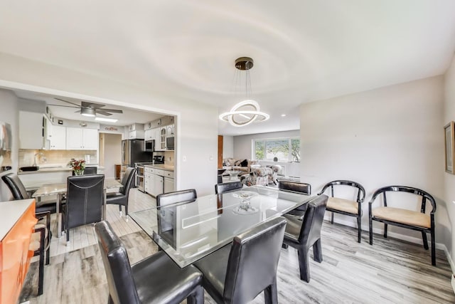 2700 E Bel Aire Dr Unit 202, Arlington Heights, IL 60004 - dining area featuring light wood-style floors, a chandelier, and ceiling fan