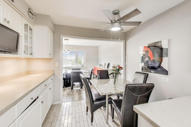 2700 E Bel Aire Dr Unit 202, Arlington Heights, IL 60004 - dining room with ceiling fan, light wood-style floors, and baseboards