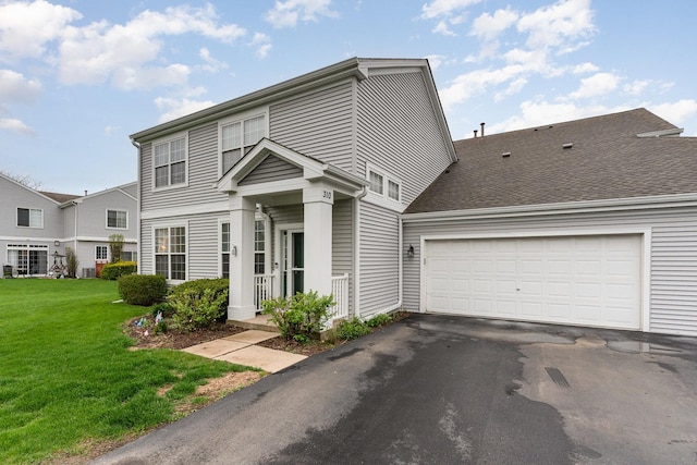 310 Cascade Ln Unit 310, Oswego, IL 60543 - view of front of home featuring driveway, a front lawn, and an attached garage