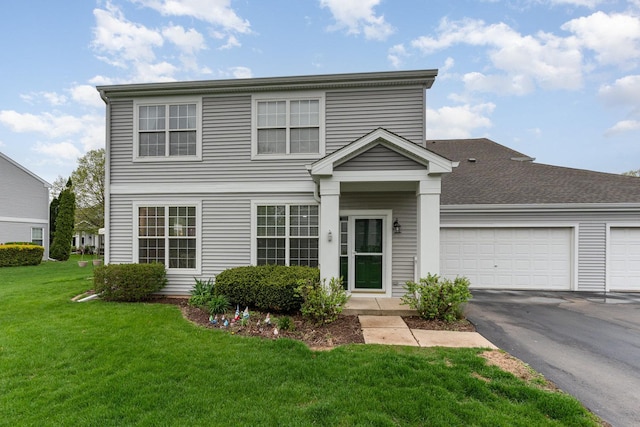 310 Cascade Ln Unit 310, Oswego, IL 60543 - traditional home featuring asphalt driveway, an attached garage, and a front lawn