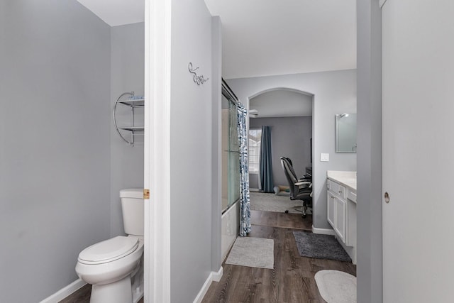 310 Cascade Ln Unit 310, Oswego, IL 60543 - full bathroom with vanity, wood finished floors, toilet, shower / bathtub combination with curtain, and baseboards