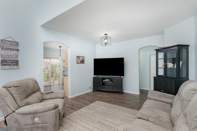 310 Cascade Ln Unit 310, Oswego, IL 60543 - living area featuring arched walkways, wood finished floors, a chandelier, and baseboards