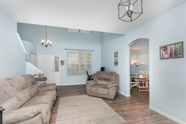 310 Cascade Ln Unit 310, Oswego, IL 60543 - living area featuring a chandelier, arched walkways, wood finished floors, and baseboards