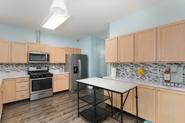 310 Cascade Ln Unit 310, Oswego, IL 60543 - kitchen featuring appliances with stainless steel finishes, light brown cabinets, tasteful backsplash, and light countertops