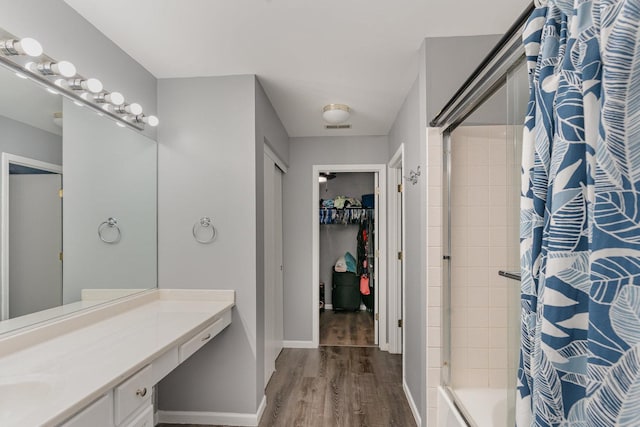 310 Cascade Ln Unit 310, Oswego, IL 60543 - full bath with wood finished floors, shower / bath combination with curtain, vanity, a spacious closet, and baseboards