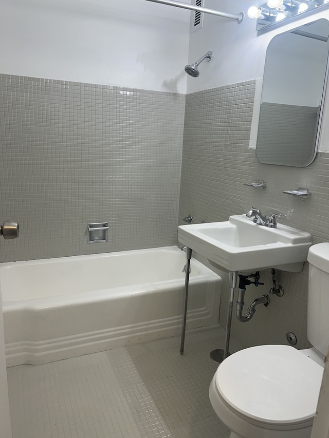 7337 S S Shore Dr Unit 216, Chicago, IL 60649 - full bathroom featuring toilet, tile patterned flooring, shower / washtub combination, and tile walls
