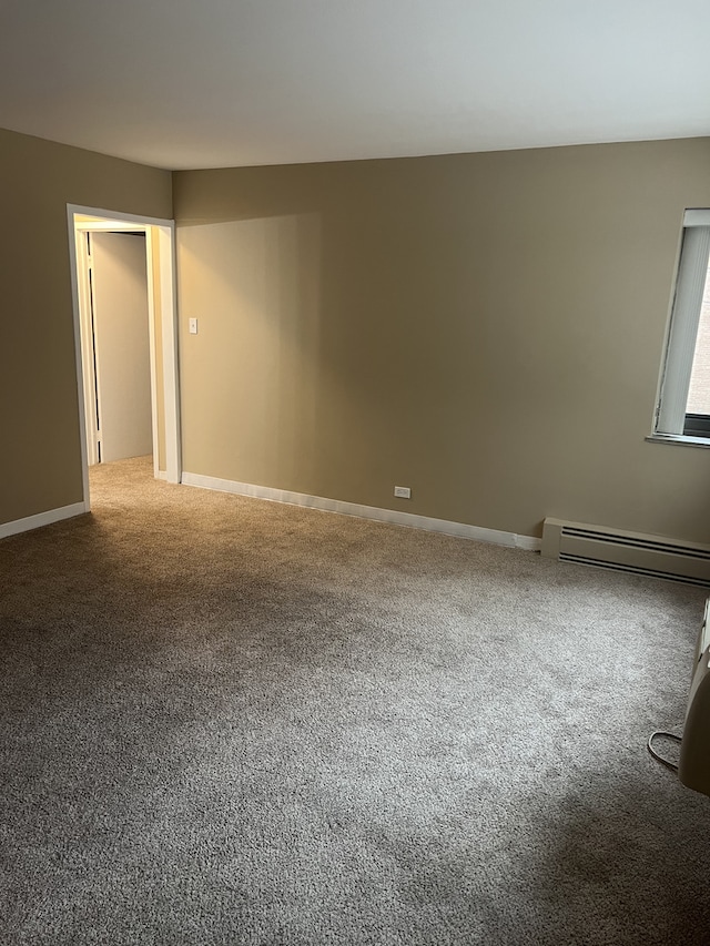 7337 S S Shore Dr Unit 216, Chicago, IL 60649 - spare room featuring a baseboard radiator, carpet flooring, and baseboards
