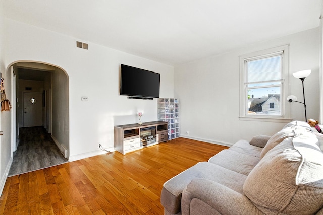1738 N Latrobe Ave, Chicago, IL 60639 - living area featuring arched walkways, wood finished floors, and baseboards