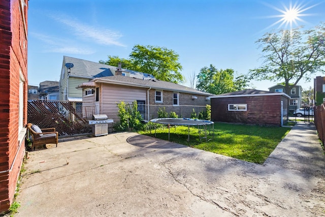 1738 N Latrobe Ave, Chicago, IL 60639 - back of property featuring a patio area, a trampoline, and an outdoor structure
