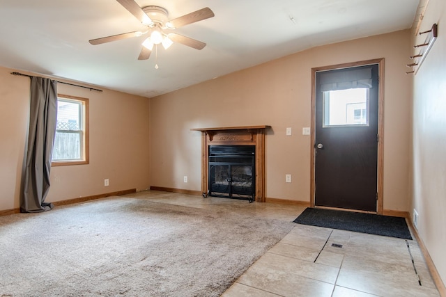 378 E Union St, Seneca, IL 61360 - unfurnished living room with lofted ceiling, a glass covered fireplace, ceiling fan, and tile patterned floors