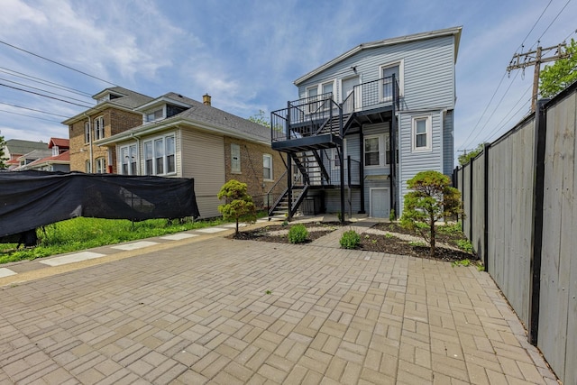7115 S Rockwell St, Chicago, IL 60629 - back of property featuring stairs and a patio