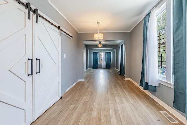 7115 S Rockwell St, Chicago, IL 60629 - corridor with a barn door, healthy amount of natural light, light wood finished floors, and crown molding