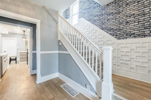 7115 S Rockwell St, Chicago, IL 60629 - staircase featuring wood finished floors, baseboards, and a towering ceiling