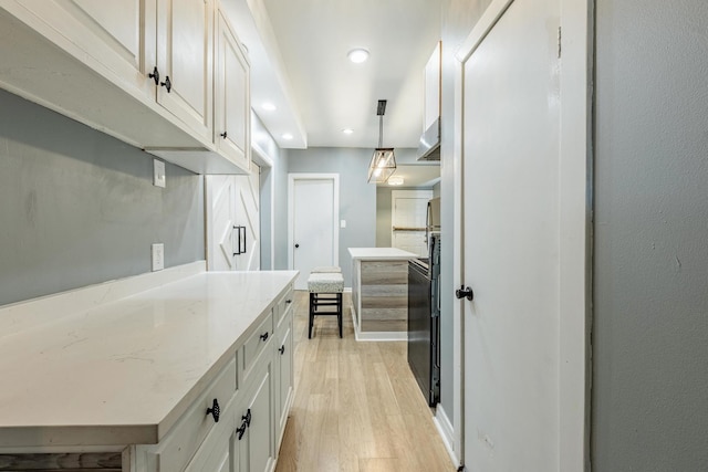 7115 S Rockwell St, Chicago, IL 60629 - kitchen with light wood-style flooring, white cabinetry, recessed lighting, decorative light fixtures, and light stone countertops