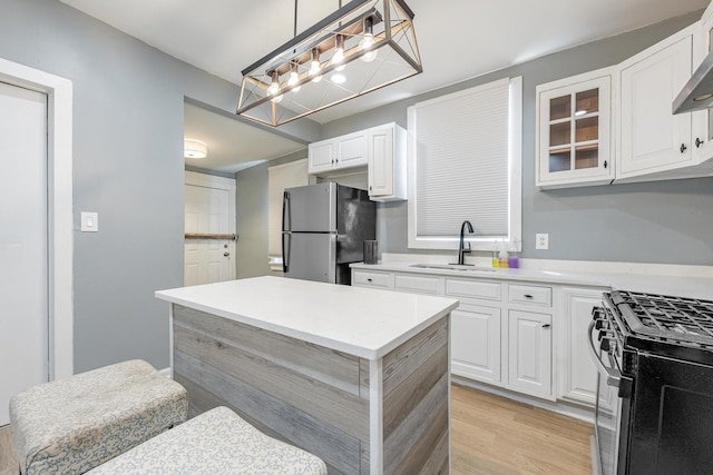 7115 S Rockwell St, Chicago, IL 60629 - kitchen with stainless steel appliances, a sink, white cabinets, glass insert cabinets, and light countertops