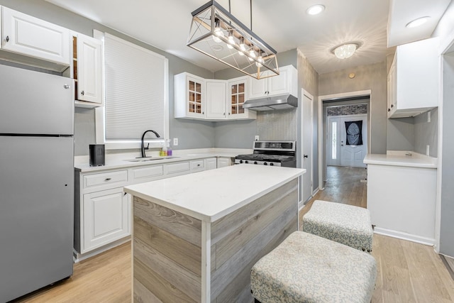 7115 S Rockwell St, Chicago, IL 60629 - kitchen featuring appliances with stainless steel finishes, a sink, under cabinet range hood, white cabinets, and glass insert cabinets