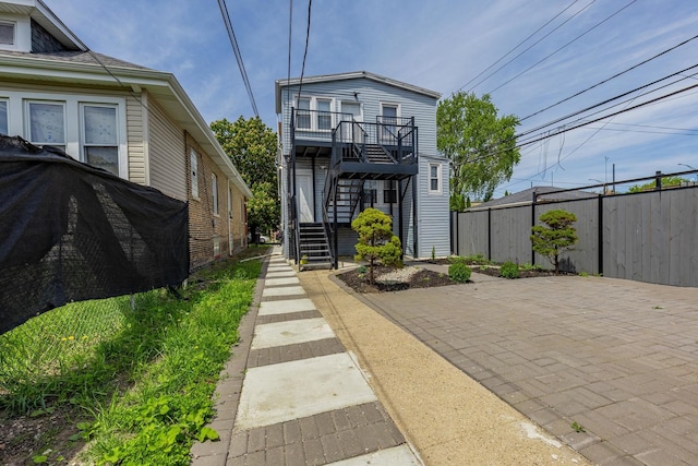 7115 S Rockwell St, Chicago, IL 60629 - view of front of home with stairway and a patio area